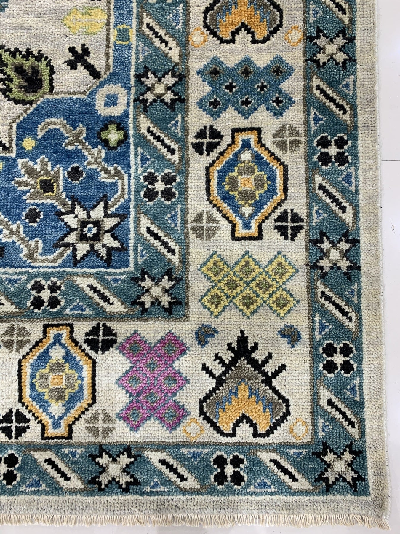 Cozy Lydia Beige Hand Knotted Wool Rug, a warm beige wool rug with subtle texture and a hand-knotted construction, invitingly displayed in a styled living space.