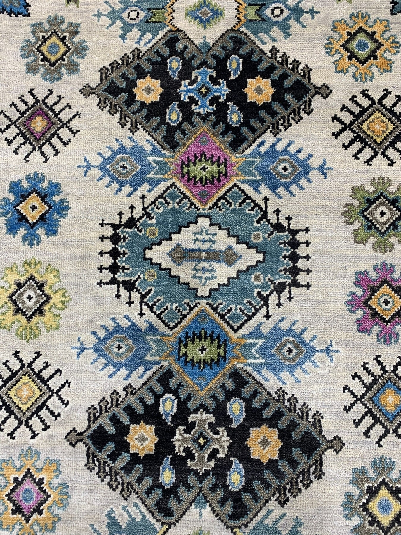 Cozy Lydia Beige Hand Knotted Wool Rug displayed in a living room setting; textured wool fibers and intricate knotting visible, blending beige and neutral tones for a warm, inviting ambiance.