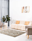 Sloane Kazak Ivory Hand Knotted Wool Rug, displaying a traditional geometric pattern in soft ivory tones, anchors a living room setting with comfortable seating and natural light.