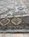 Sloane Kazak Ivory Hand Knotted Wool Rug, displaying its intricate patterns and soft texture, seen in a bright, airy living space with modern furniture.