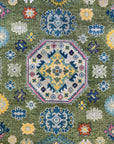 Inviting Kazak Light Green Hand Knotted Wool Rug, displaying a traditional geometric pattern in light green, ivory, and terracotta tones, anchoring a living room setting with classic elegance.