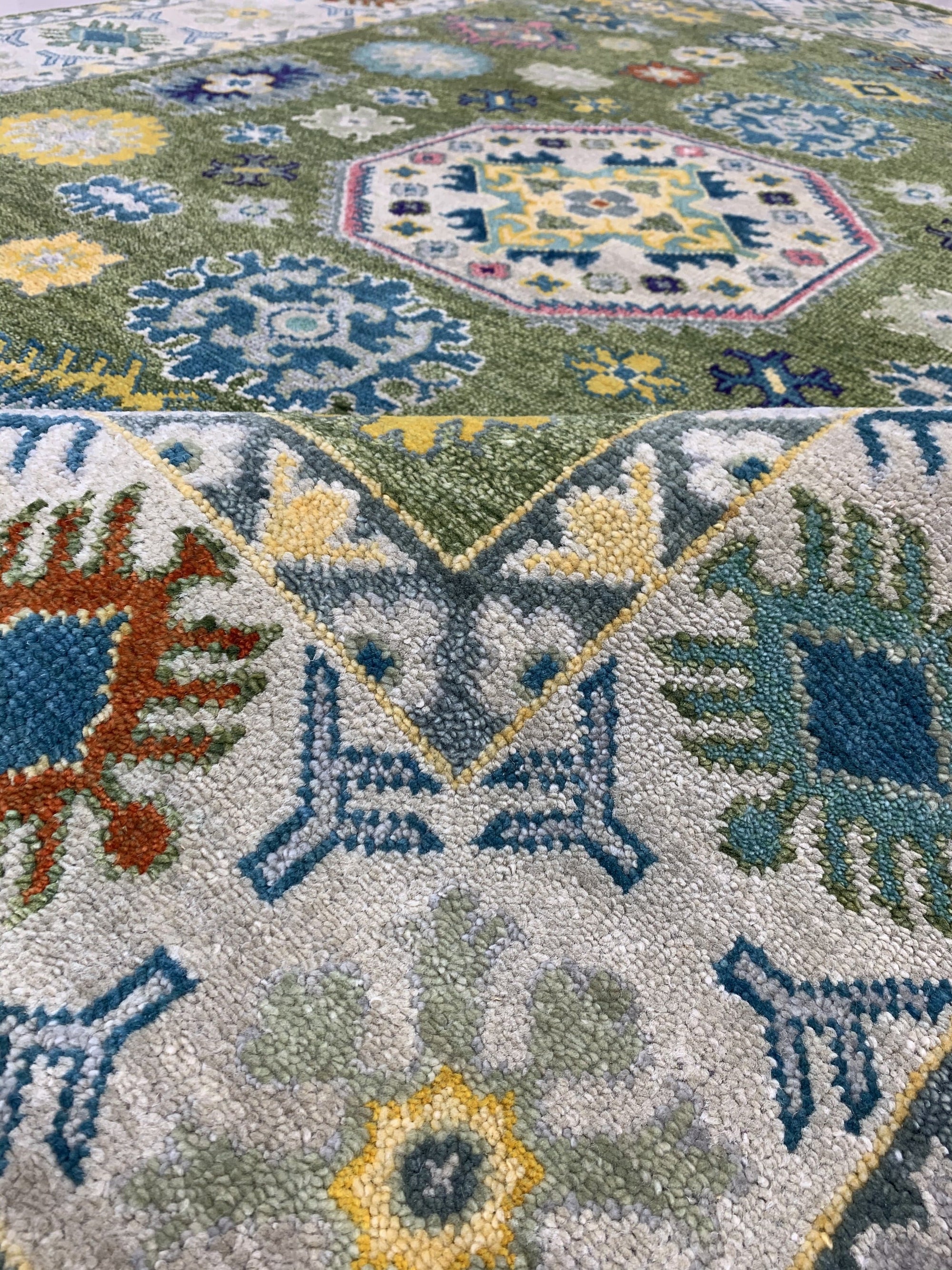 Inviting Kazak Light Green Hand Knotted Wool Rug, showcasing a traditional geometric pattern in shades of light green and cream, hand-knotted for durable luxury, seen in a lifestyle setting suggesting warmth and comfort.