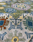 Inviting Kazak Light Green Hand Knotted Wool Rug, showcasing a traditional geometric pattern in shades of light green and cream, hand-knotted for durable luxury, seen in a lifestyle setting suggesting warmth and comfort.