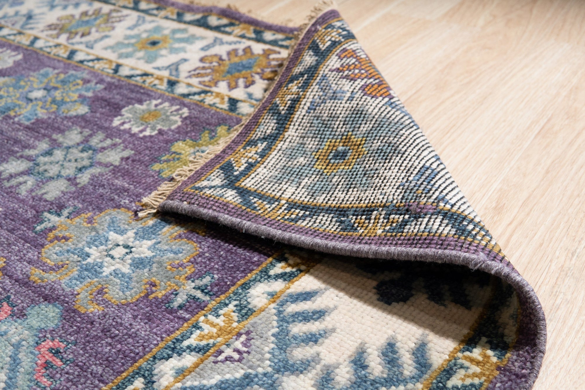 Cassandra Kazak Purple Hand Knotted Wool Rug, vibrant geometric pattern in deep purples and reds, showcasing intricate detailing and the luxurious texture of hand-knotted wool.