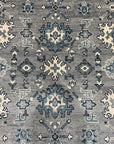Maya Oushak Silver Hand Knotted Wool Rug, displaying its intricate, traditional Oushak design in muted silver and ivory tones, laying elegantly on a hardwood floor.