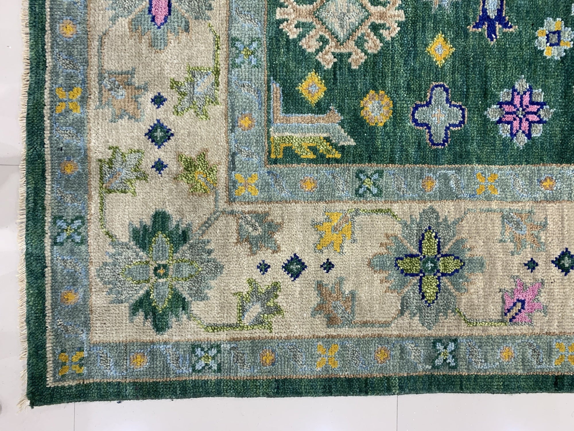 Isla Kazak Green Hand Knotted Wool Rug, showcasing a detailed, traditional Kazak design with geometric patterns in shades of green, red, and cream.