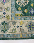 Isla Kazak Green Hand Knotted Wool Rug, showcasing a detailed, traditional Kazak design with geometric patterns in shades of green, red, and cream.