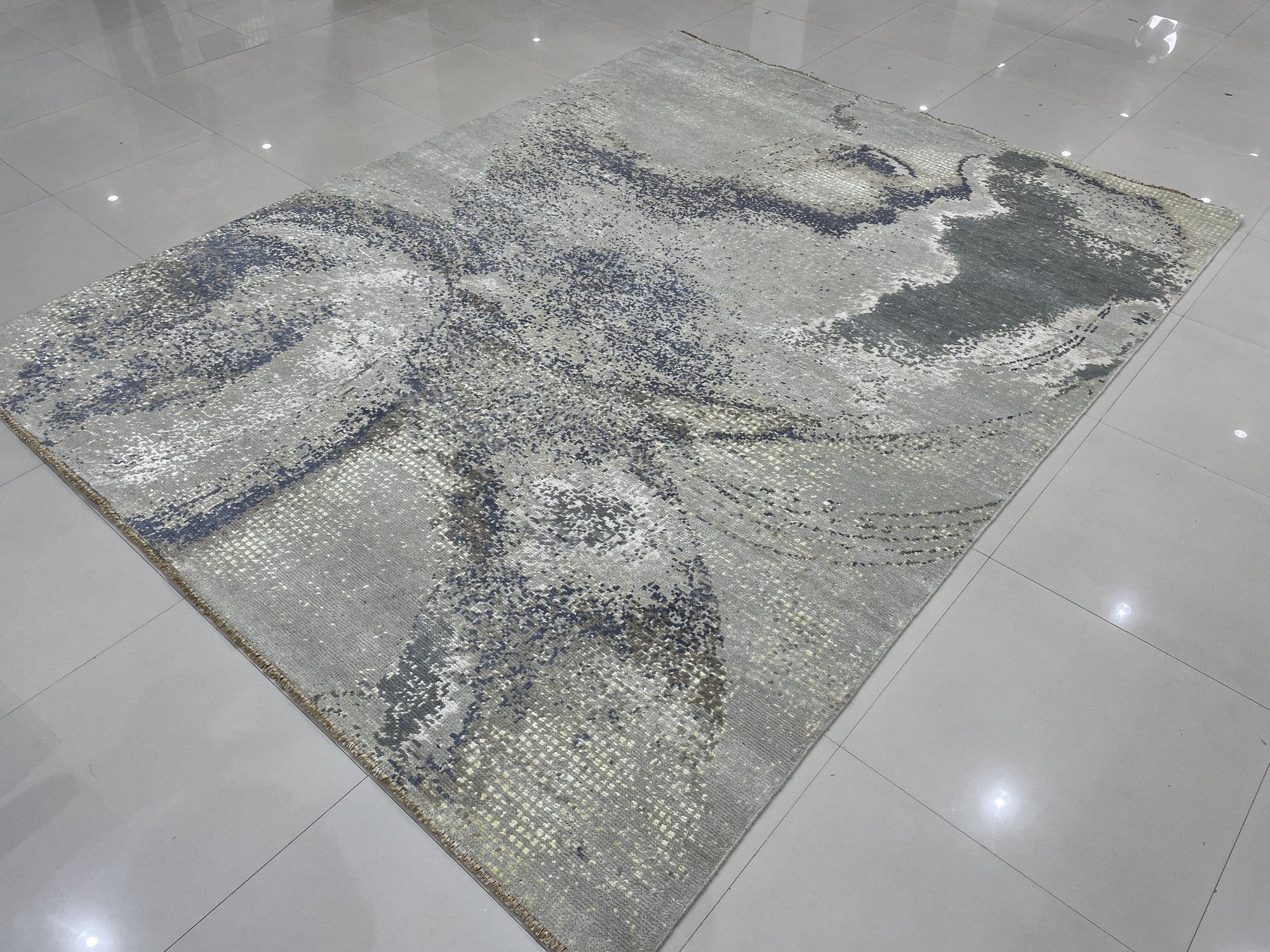 Lydia Cassandra Gray Hand Knotted Wool Rug, its subtle gray tones and intricate hand-knotted wool texture grounding a contemporary living space.