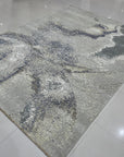 Lydia Cassandra Gray Hand Knotted Wool Rug, its subtle gray tones and intricate hand-knotted wool texture grounding a contemporary living space.