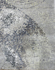 Lydia Cassandra Gray Hand Knotted Wool Rug, a sophisticated gray wool rug featuring a subtle, hand-knotted design, laid on a light hardwood floor, evoking a sense of understated elegance.