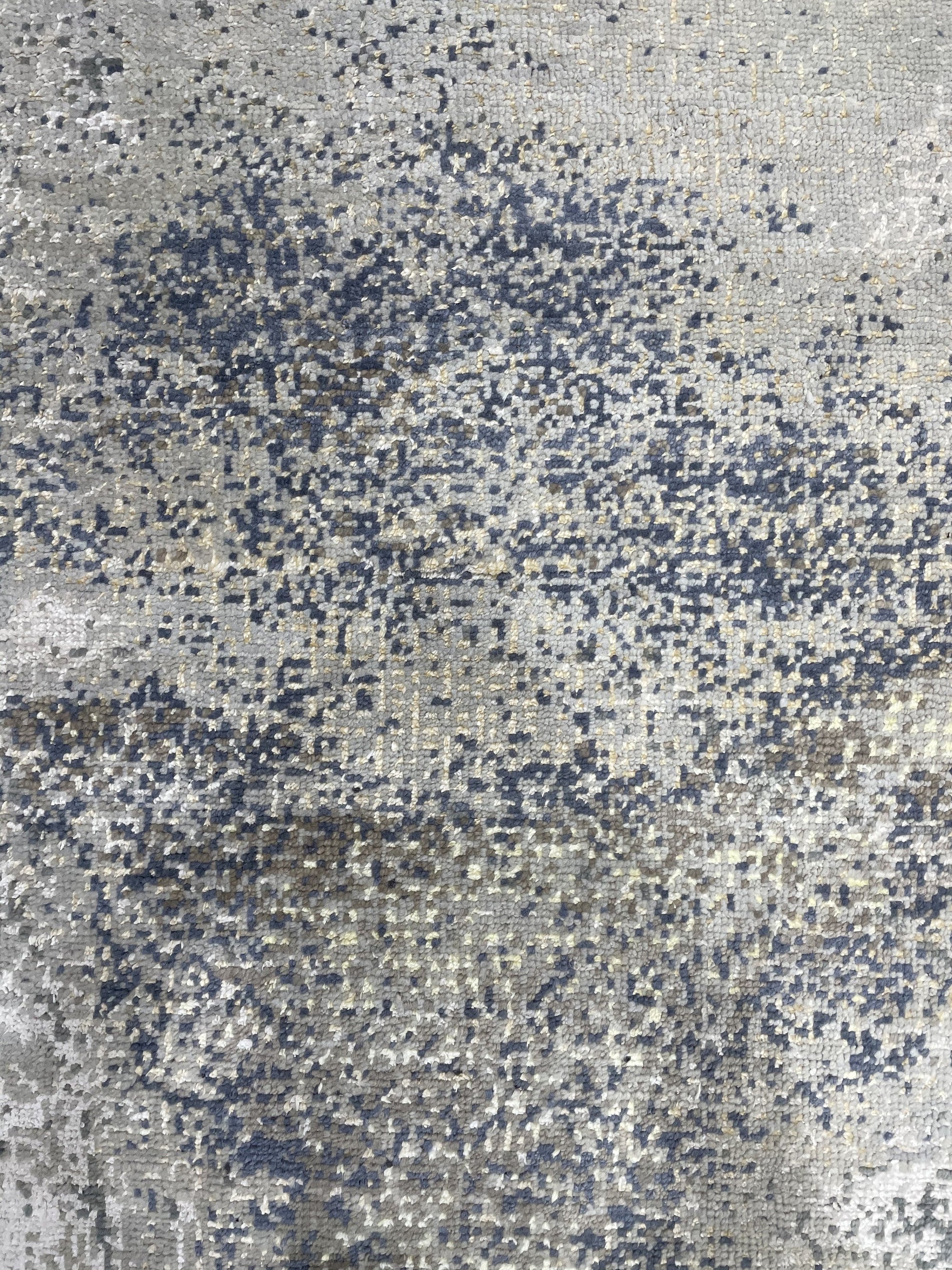 Lydia Cassandra Gray Hand Knotted Wool Rug, featuring subtle textures and a sophisticated gray palette, displayed in a styled room setting.