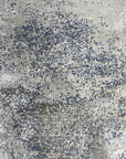 Lydia Cassandra Gray Hand Knotted Wool Rug, featuring subtle textures and a sophisticated gray palette, displayed in a styled room setting.