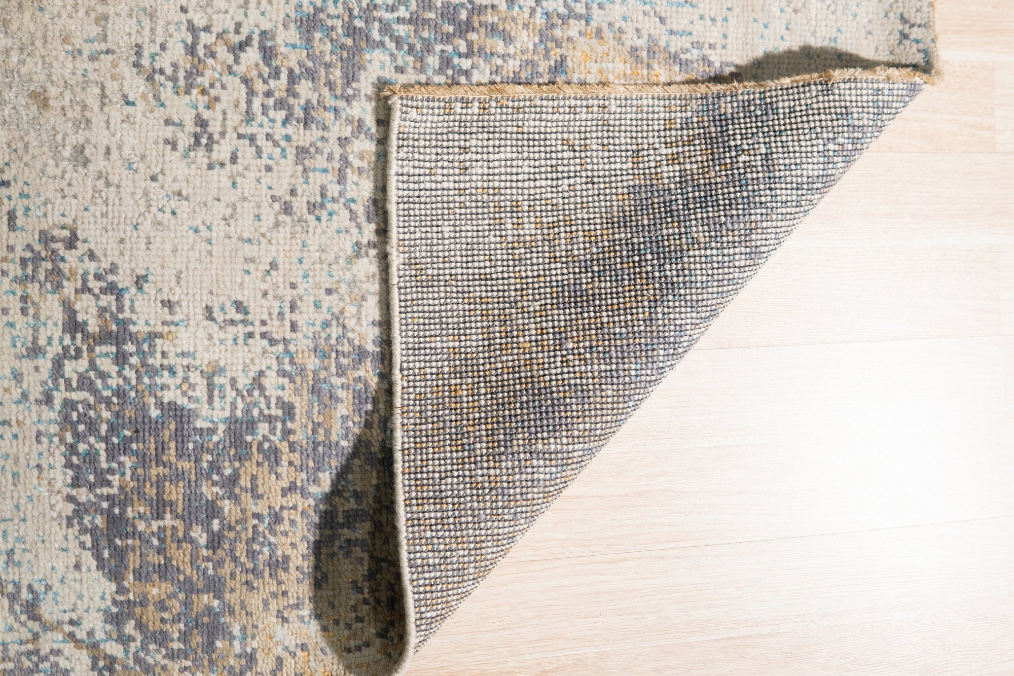 Lydia Cassandra Gray Hand Knotted Wool Rug, soft gray hues and subtle geometric patterns create a sophisticated focal point in a bright, modern living space.