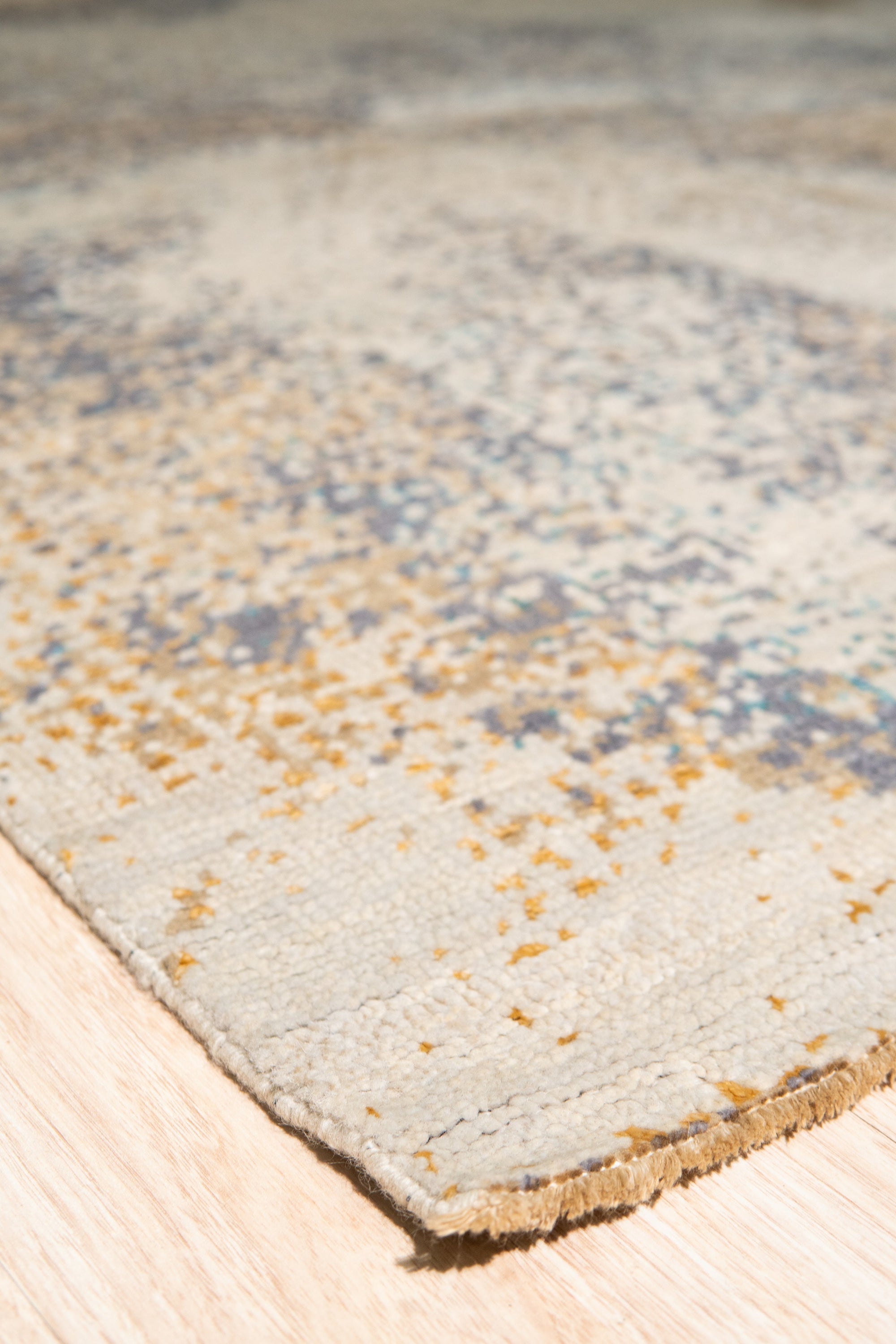 Lydia Cassandra Gray Hand Knotted Wool Rug, showcasing a textured gray field with subtle, abstract patterns, hand-knotted construction evident in its nuanced pile.