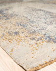 Lydia Cassandra Gray Hand Knotted Wool Rug, showcasing a textured gray field with subtle, abstract patterns, hand-knotted construction evident in its nuanced pile.