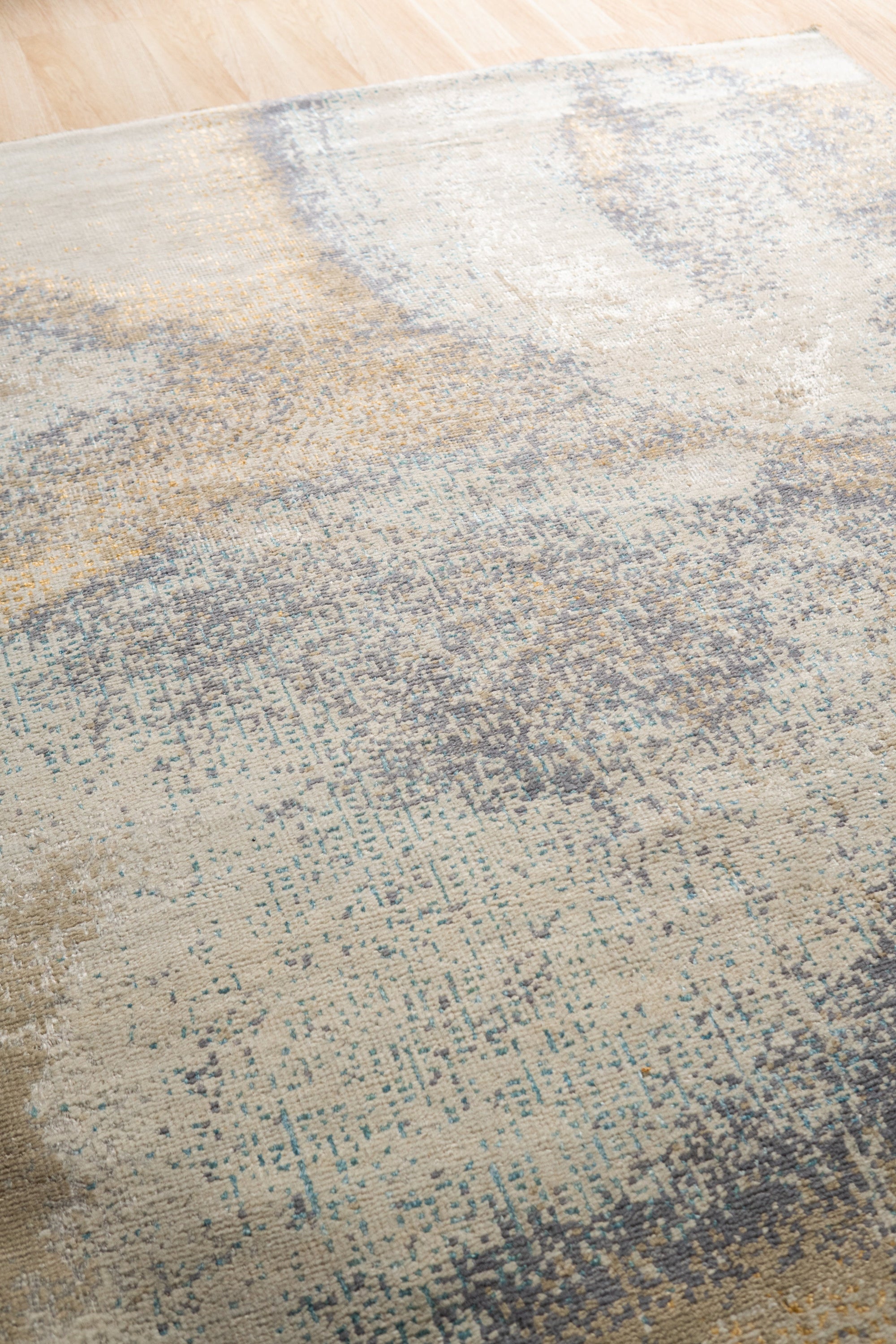 Lydia Cassandra Gray Hand Knotted Wool Rug in a living room setting, its intricate pattern complementing modern furniture.