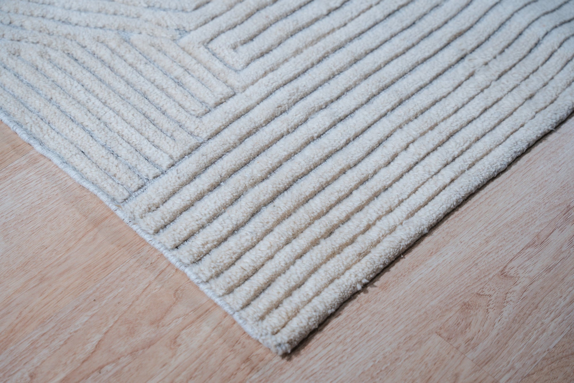 Celia Lila Ivory Hand Knotted Wool Rug, its delicate lilac and ivory hues blending in a sophisticated floor covering. Hand knotted wool construction offers texture and depth.