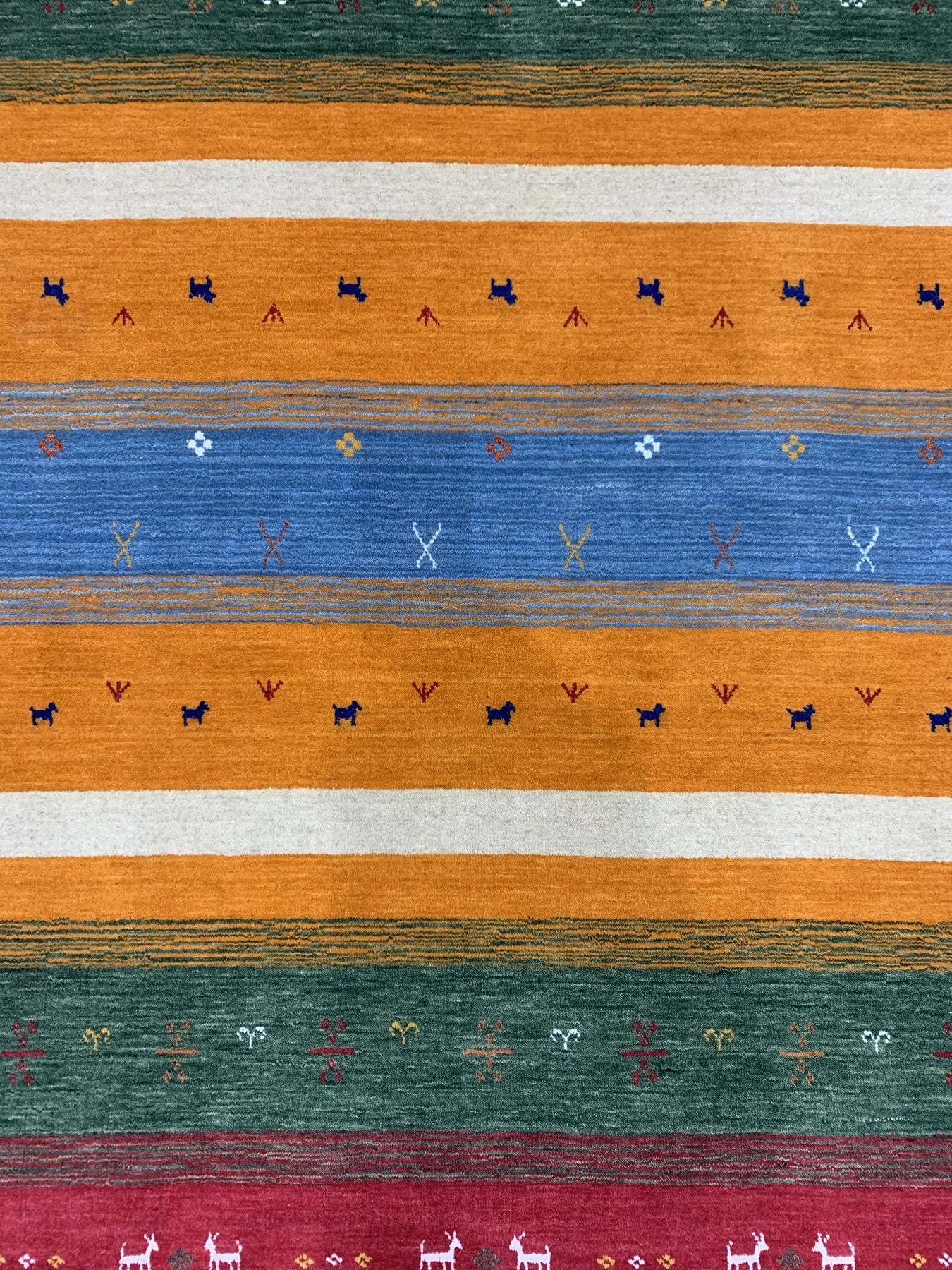 Timeless Gabbeh Blue Handmade Wool Rug, a saturated blue and cream wool rug featuring a simple, geometric design, seen in a bright, well-lit studio setting.