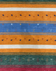 Timeless Gabbeh Blue Handmade Wool Rug, a saturated blue and cream wool rug featuring a simple, geometric design, seen in a bright, well-lit studio setting.
