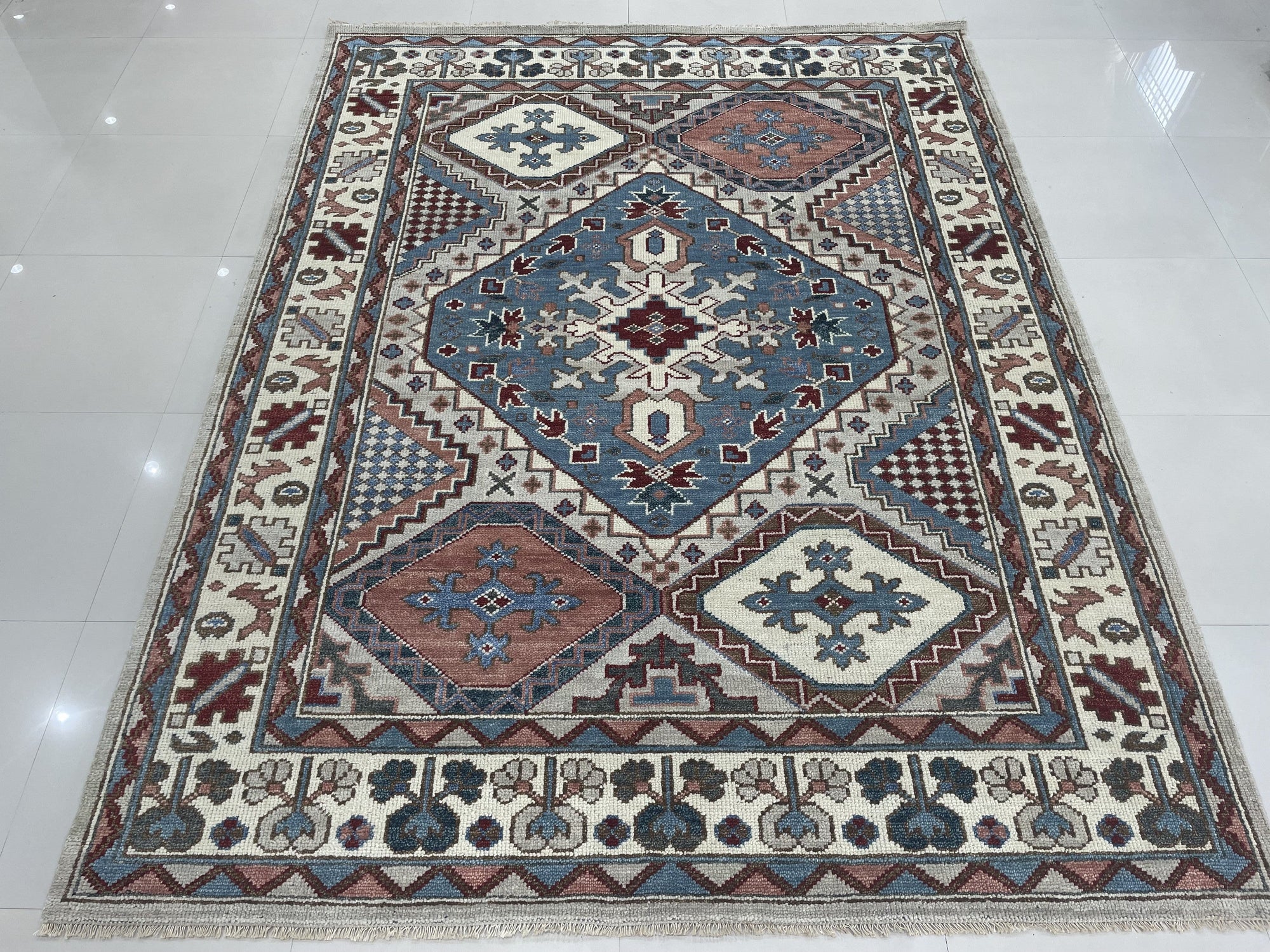 Rustic Isla Gray Hand Knotted Wool Rug, showcasing its subtle gray hues and hand-knotted texture, rests on a light wood floor, creating a calming and sophisticated living space.