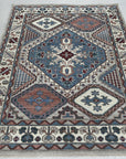 Rustic Isla Gray Hand Knotted Wool Rug, showcasing its subtle gray hues and hand-knotted texture, rests on a light wood floor, creating a calming and sophisticated living space.