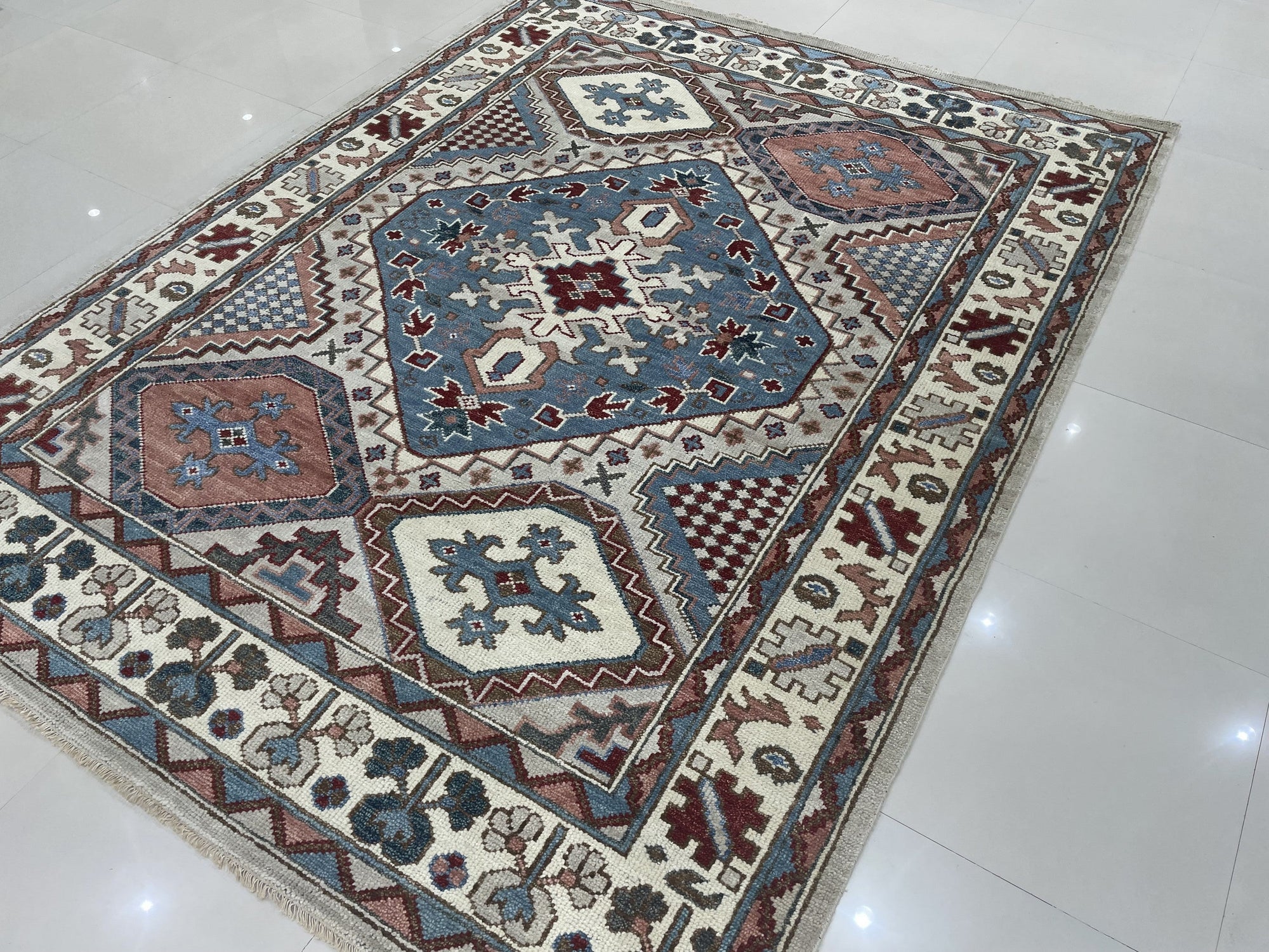 Rustic Isla Gray Hand Knotted Wool Rug, showcasing its subtle gray tones and hand-knotted construction within a warmly lit interior setting.