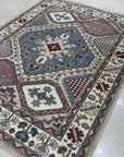 Rustic Isla Gray Hand Knotted Wool Rug, showcasing its subtle gray tones and hand-knotted construction within a warmly lit interior setting.