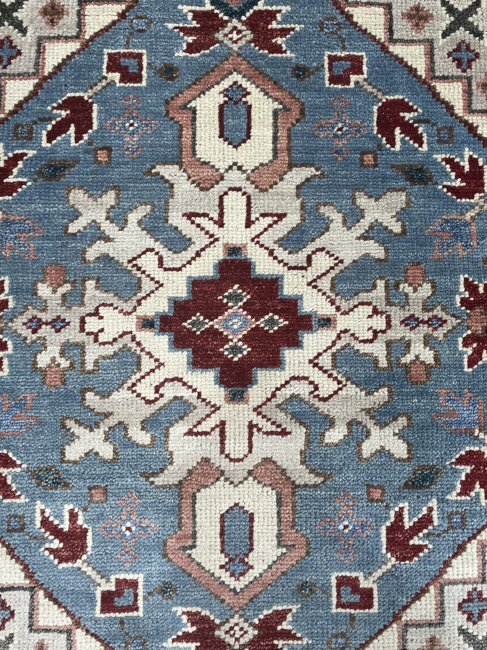 Rustic Isla Gray Hand Knotted Wool Rug, showcasing a subtle, textured gray field with a distressed, vintage-inspired design, adding warmth and understated elegance to a living space.