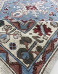 Rustic Isla Gray Hand Knotted Wool Rug, a textured grey wool rug with subtle patterns and fringed edges, lies on a light wood floor creating a warm, inviting atmosphere.