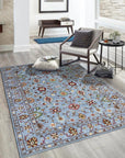 Elena Oriental Blue Hand Knotted Wool Rug, showcasing a detailed traditional design with intricate patterns in shades of blue, ivory, and subtle accents, displayed in a well-lit room setting.