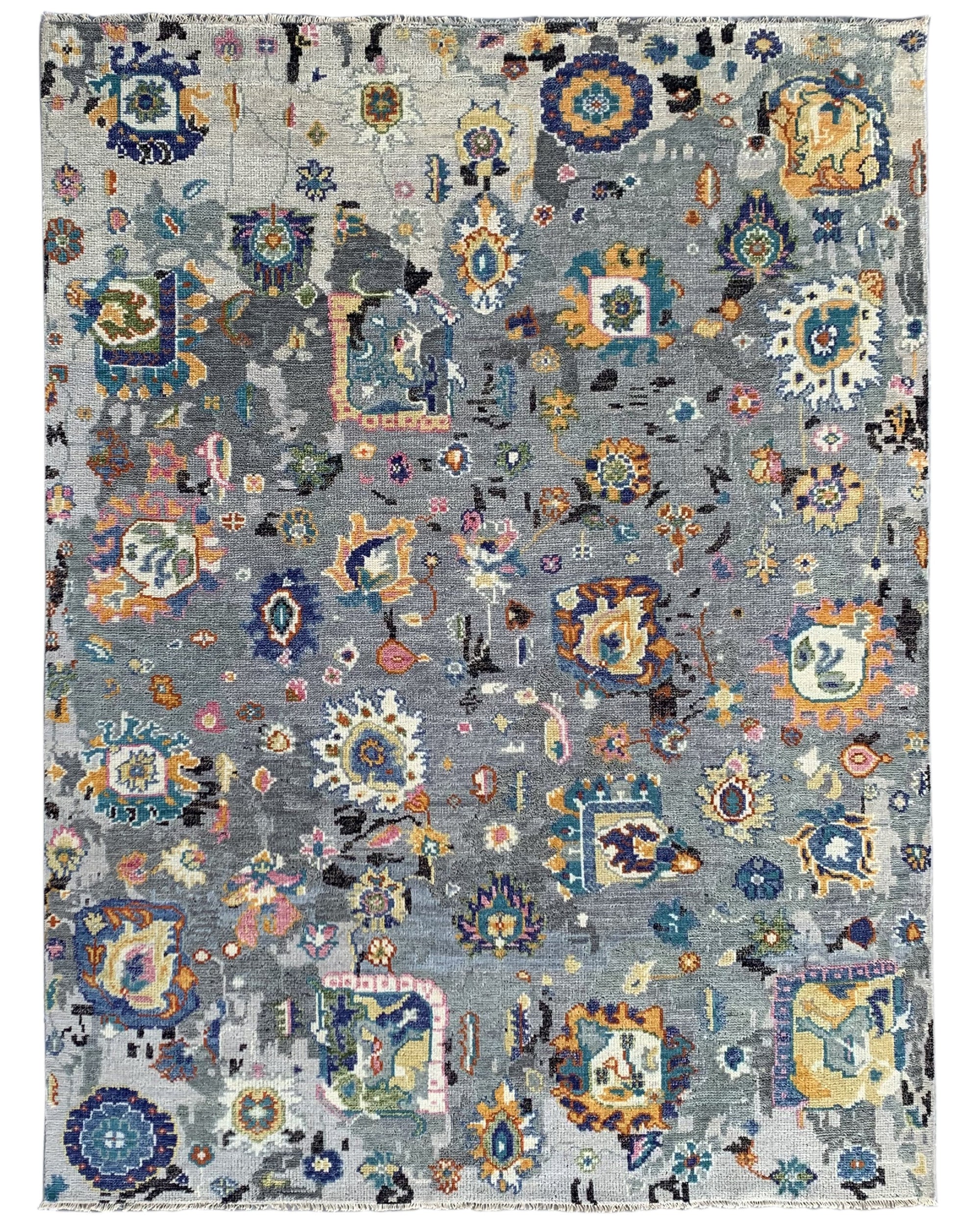 Classic Willow Gray Hand Knotted Wool Rug displayed in a bright living space; its intricate, subtle pattern and hand-knotted wool construction add texture and warmth to the room.