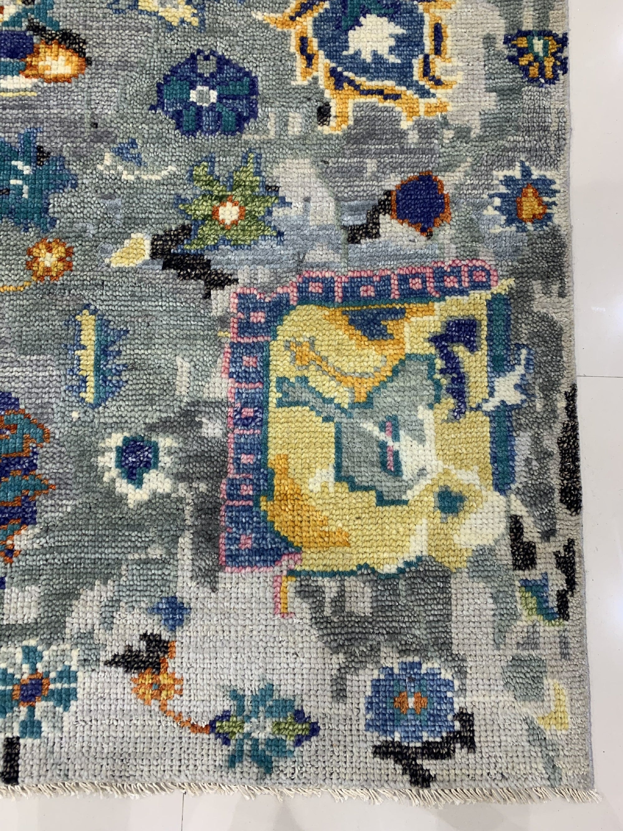 Classic Willow Gray Hand Knotted Wool Rug, a soft gray wool rug hand-knotted with a subtle, timeless design, rests on a light wood floor, its neutral tones creating a serene and inviting space.