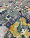 Classic Willow Gray Hand Knotted Wool Rug, seen in a living room setting. Soft grays and subtle variations in the hand-knotted wool create a calming and elegant foundation for modern furniture.