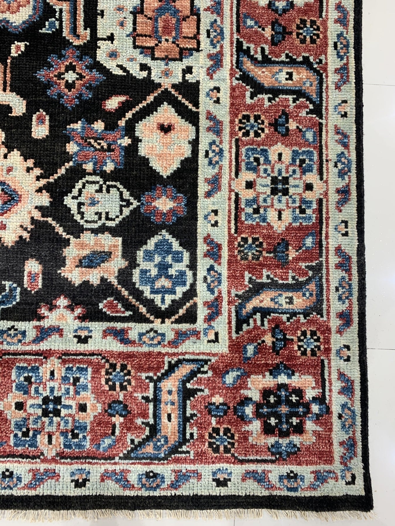 Timeless Oriental Charcoal Hand Knotted Wool Rug, displaying intricate traditional patterns in shades of charcoal, lies flat showcasing its hand-knotted wool construction.