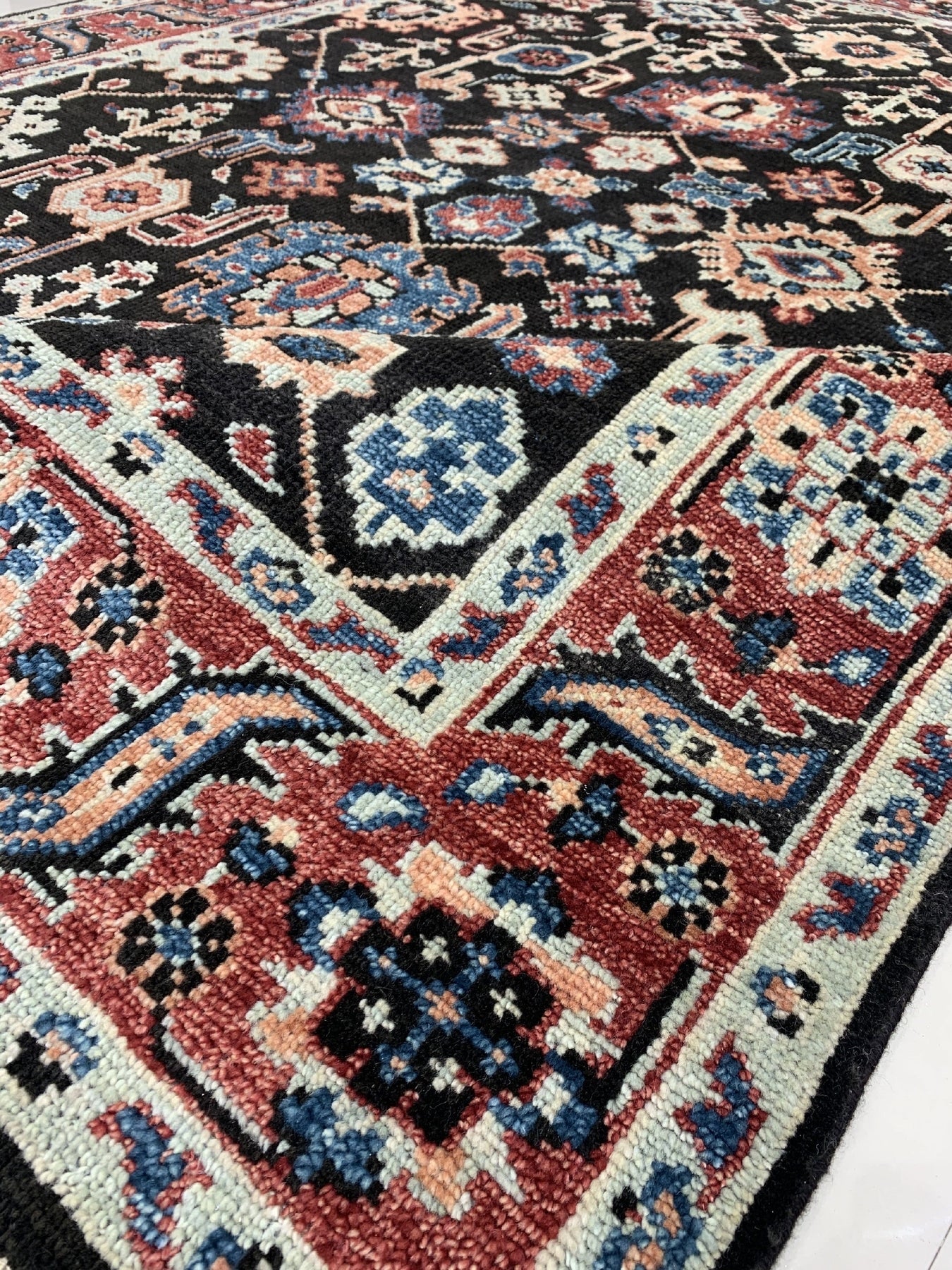 Timeless Oriental Charcoal Hand Knotted Wool Rug, displaying its intricate details and rich charcoal hues, showcased in a well-lit living room setting.