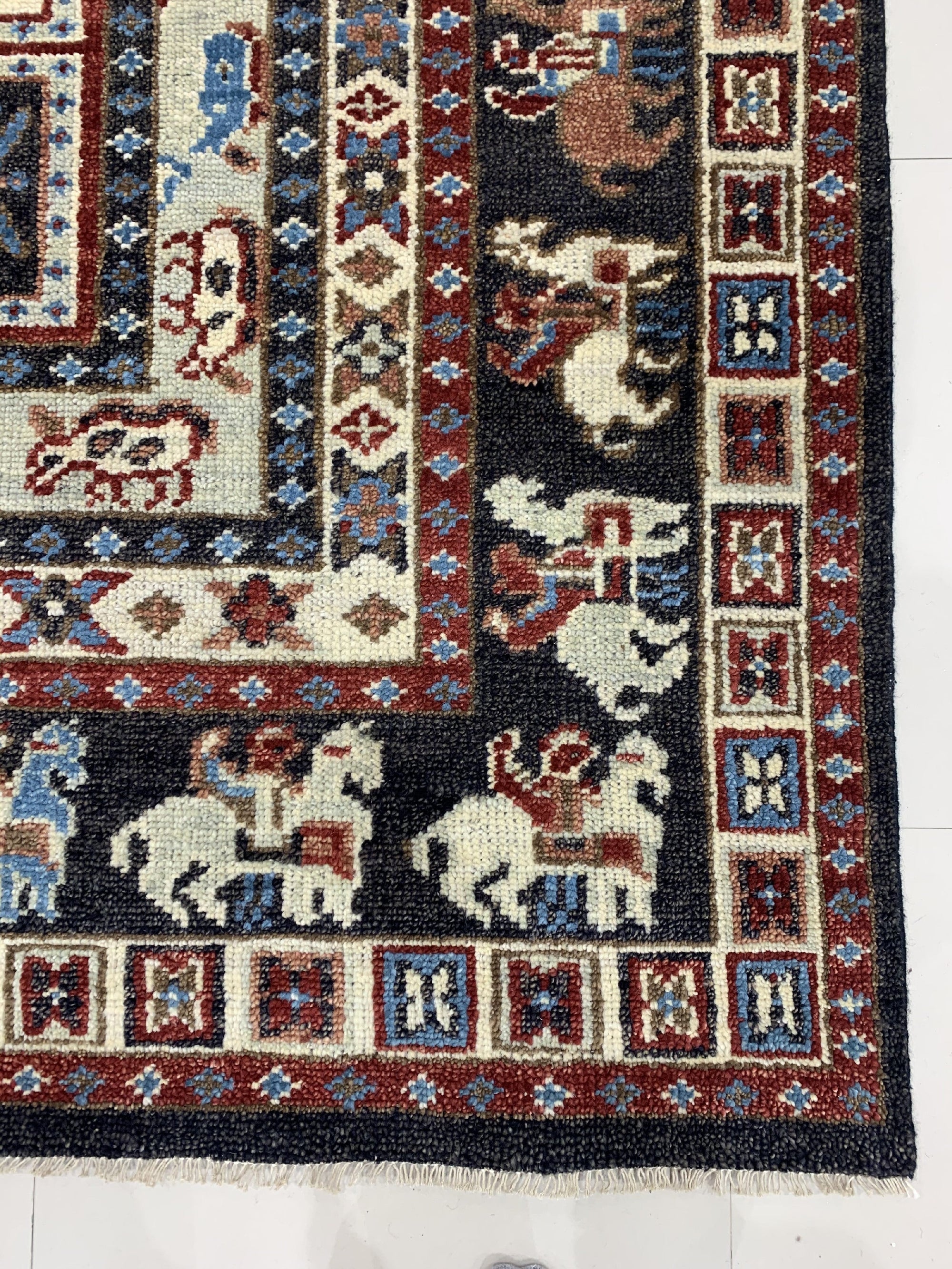 Willow Oriental Charcoal Hand Knotted Wool Rug, its intricate oriental design rendered in shades of charcoal, softening a modern living space.