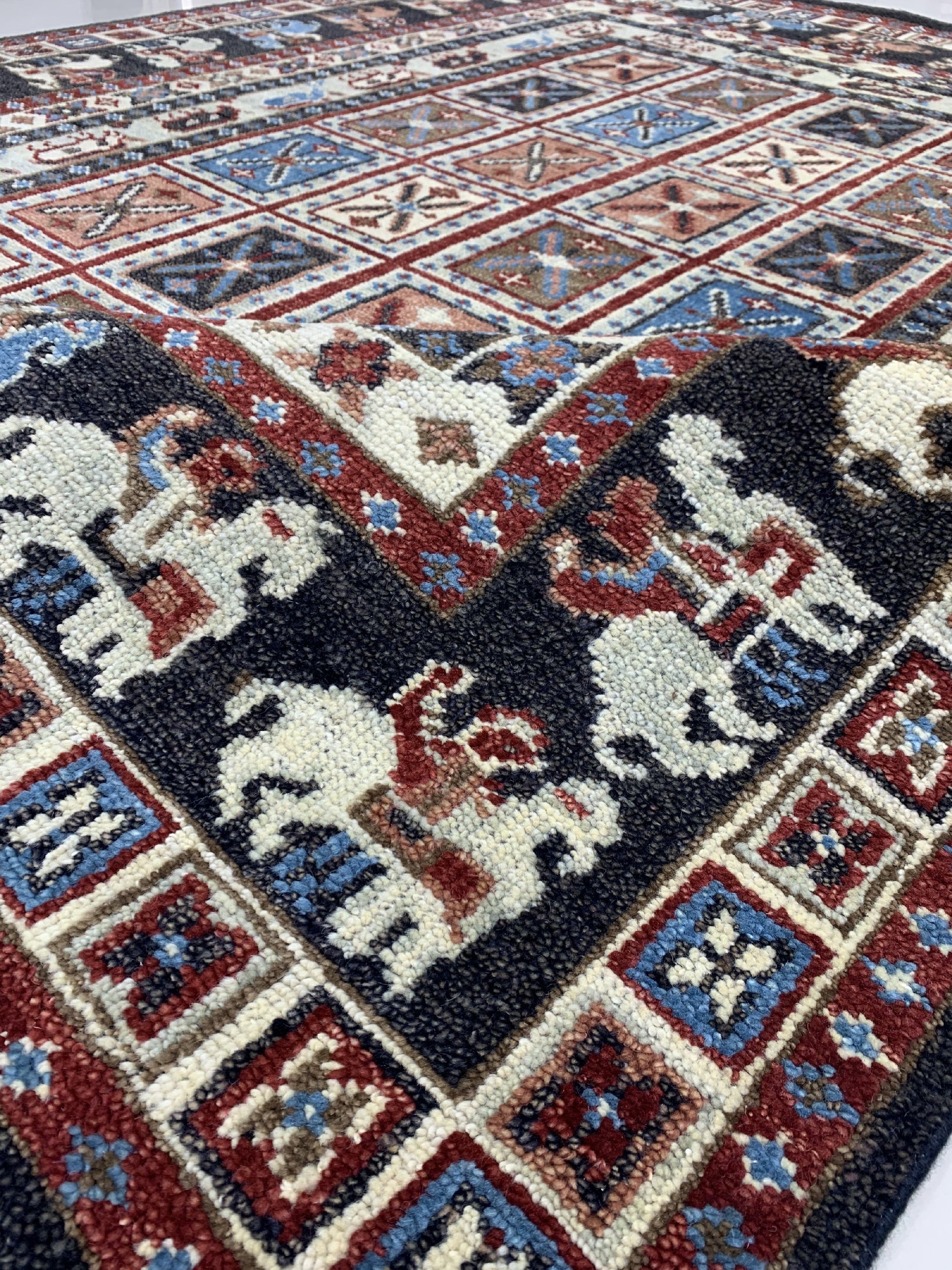 Willow Oriental Charcoal Hand Knotted Wool Rug, a charcoal-toned hand-knotted wool rug featuring an intricate oriental design, displayed within a modern interior setting.