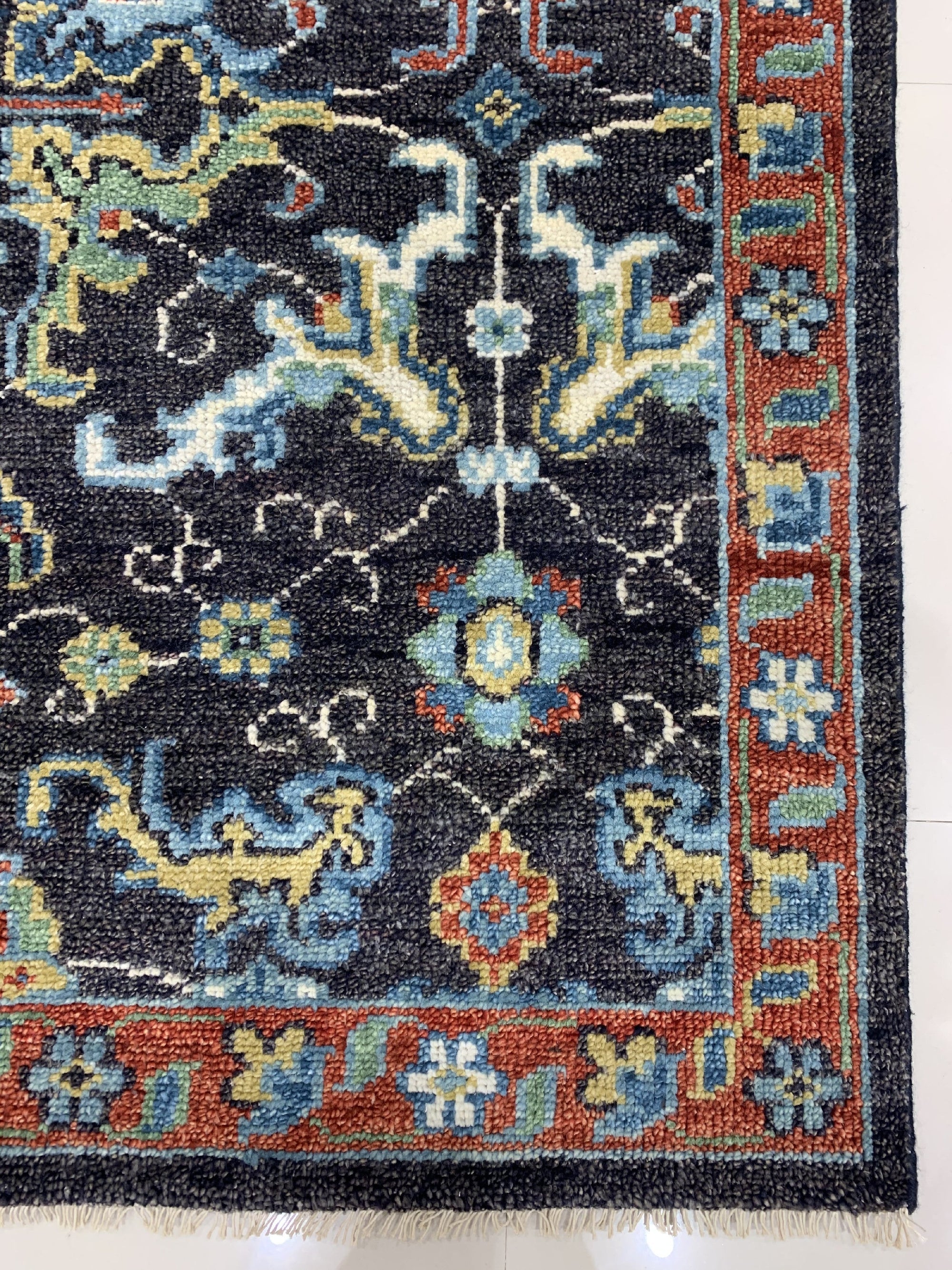 Delicate Oriental Brown Hand Knotted Wool Rug displayed on a light hardwood floor, its intricate floral patterns in shades of brown, beige, and ochre adding warmth and sophistication to the space.