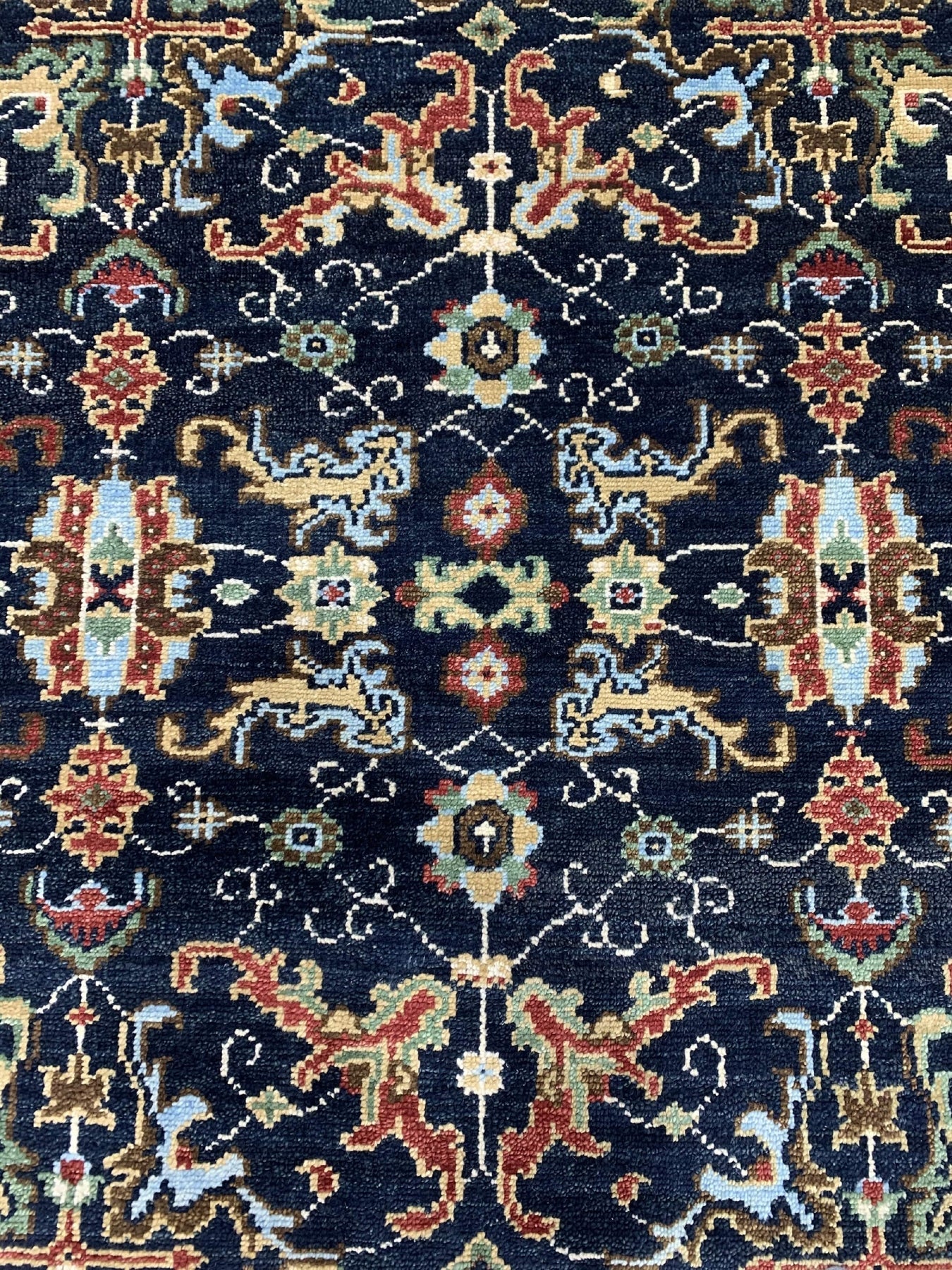 Chloe Oriental Navy Hand Knotted Wool Rug, rich navy tones and intricate oriental patterns grace this hand-knotted wool rug, displayed in a well-lit interior setting.