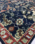 Chloe Oriental Navy Hand Knotted Wool Rug, displaying intricate patterns in deep navy and complementing hues; hand-knotted wool construction offers rich texture and enduring beauty.