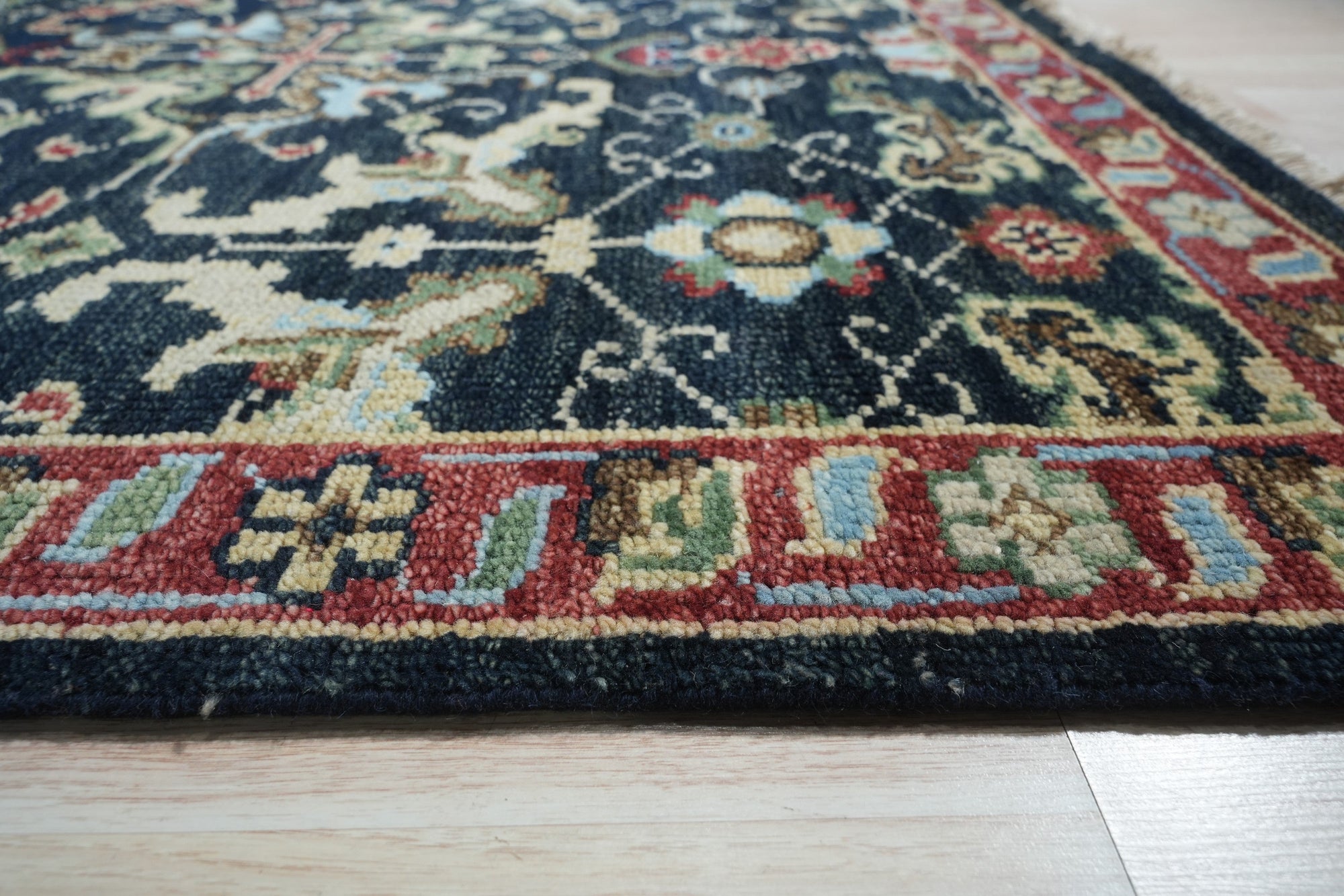 Chloe Oriental Navy Hand Knotted Wool Rug, showcasing its intricate oriental design in deep navy hues, hand-knotted wool construction adding richness and texture to an unseen room.