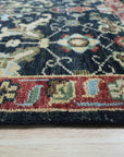 Chloe Oriental Navy Hand Knotted Wool Rug, showcasing its intricate oriental design in deep navy hues, hand-knotted wool construction adding richness and texture to an unseen room.