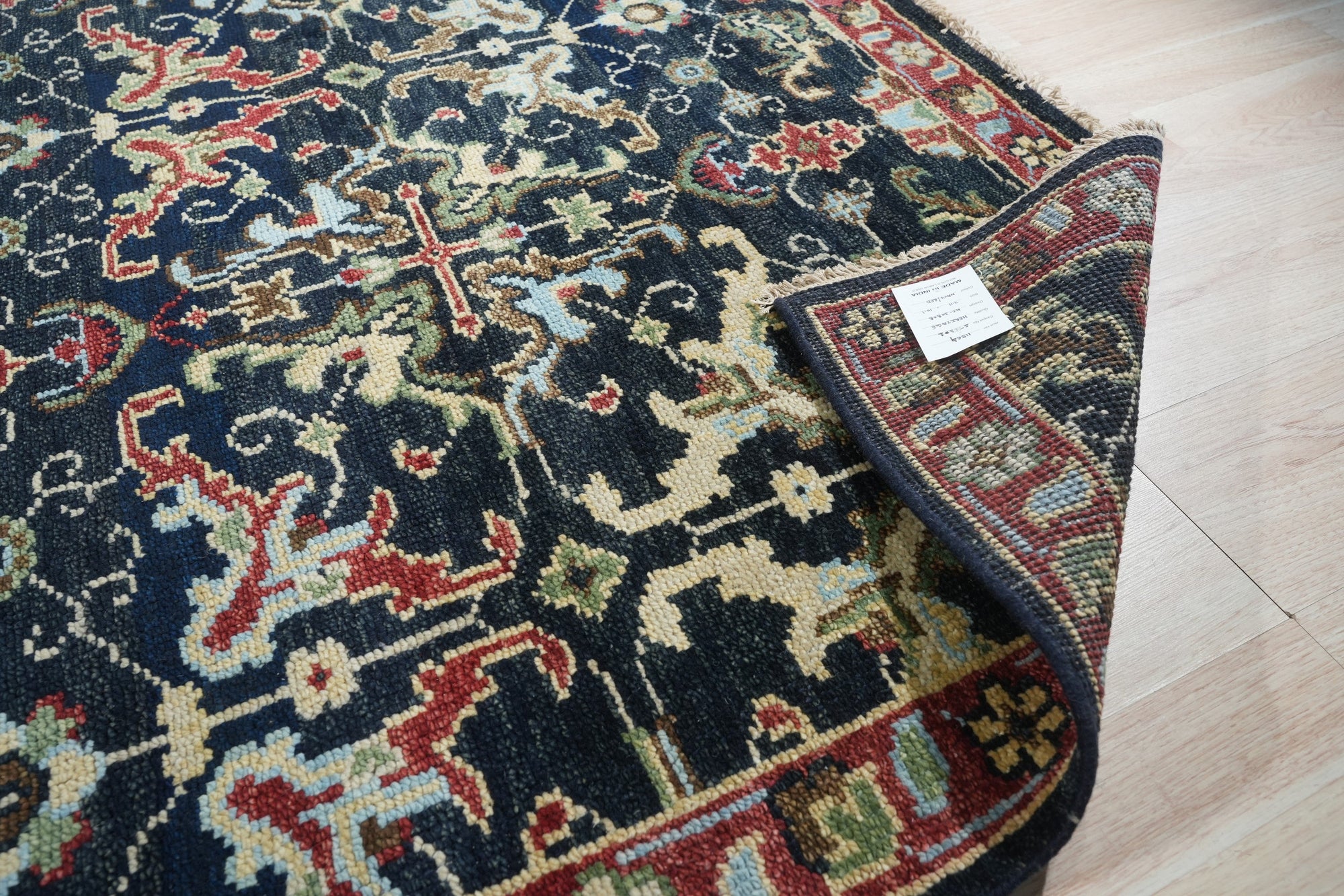 Chloe Oriental Navy Hand Knotted Wool Rug, a hand-knotted wool rug in deep navy with intricate oriental patterns, elegantly displayed.
