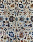 Iris Oushak Beige Hand Knotted Wool Rug, showcasing its delicate floral patterns and soft beige hues within a sunlit living space.