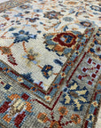 Iris Oushak Beige Hand Knotted Wool Rug, warm beige tones and intricate floral patterns softly define a refined space, showcasing the rug's hand-knotted construction and classic Oushak design.