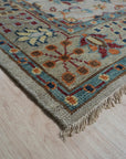 Iris Oushak Beige Hand Knotted Wool Rug, its intricate floral patterns and soft beige hues lending warmth to a bright, modern living space.