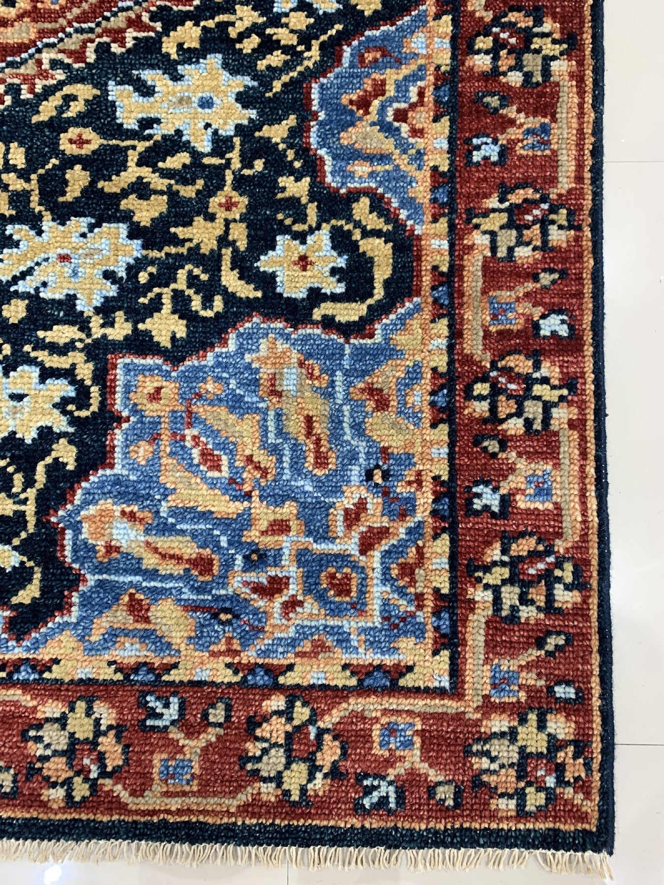 Bianca Traditional Navy Hand Knotted Wool Rug, showcasing its rich navy hues and intricate, classic patterns. Woolen threads create depth and texture in this timeless floor covering, seen in a detailed close-up shot.