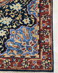 Bianca Traditional Navy Hand Knotted Wool Rug, showcasing its rich navy hues and intricate, classic patterns. Woolen threads create depth and texture in this timeless floor covering, seen in a detailed close-up shot.