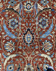 Rustic Oriental Red Hand Knotted Wool Rug displayed on a light wood floor. The hand-knotted construction is evident in its intricate, traditional Oriental pattern in shades of red, cream, and navy. Warm, inviting texture promises comfort and style.