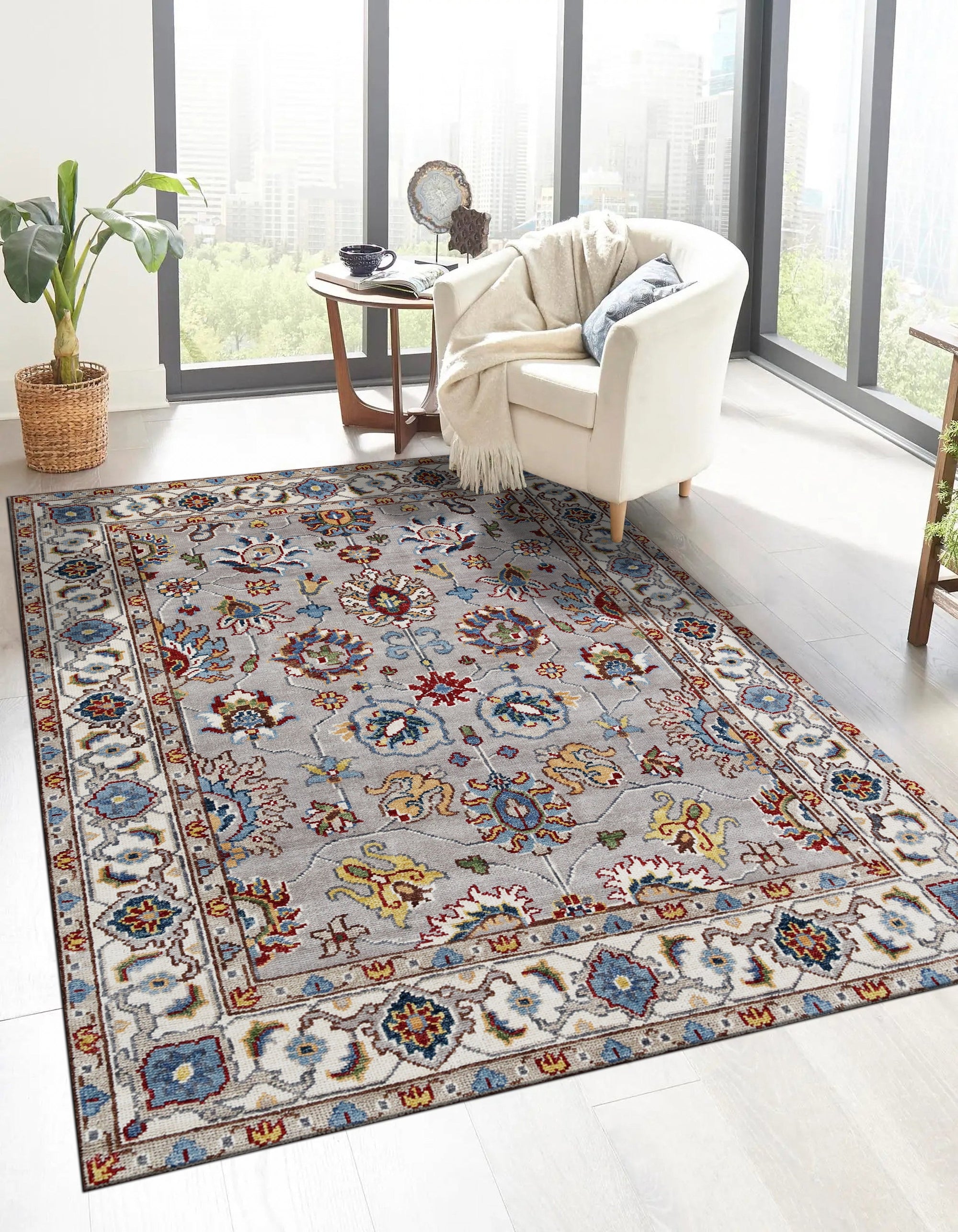 Enchanting Oriental Gray Hand Knotted Wool Rug, a textured wool rug with a traditional oriental pattern in varying shades of gray, laid on a light wooden floor.